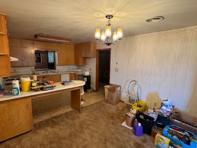 kitchen featuring carpet flooring, sink, an inviting chandelier, white dishwasher, and decorative light fixtures