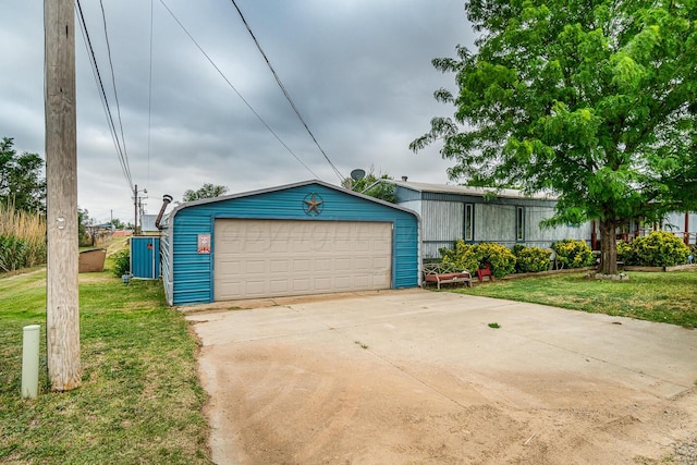 view of front of property with a front yard, an outdoor structure, and a garage