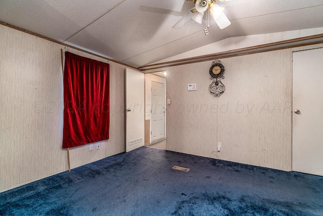 spare room with lofted ceiling, ceiling fan, and carpet floors