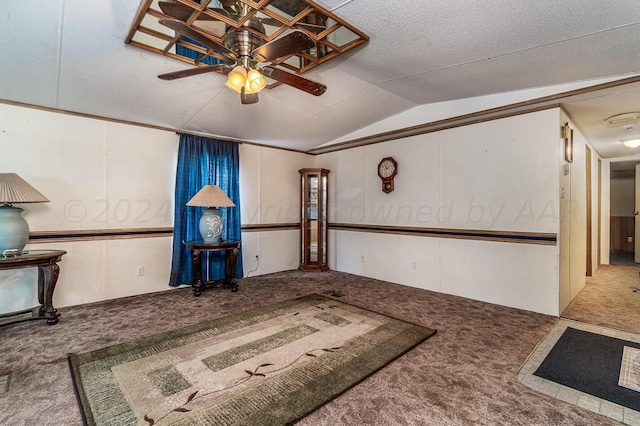 interior space with a textured ceiling, light colored carpet, lofted ceiling, and ceiling fan