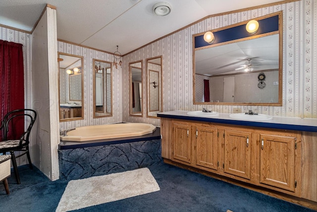 bathroom featuring a tub, ornamental molding, ceiling fan, vanity, and vaulted ceiling