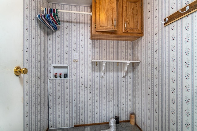 clothes washing area with washer hookup and cabinets