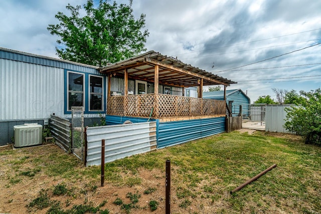 exterior space with a lawn and central AC