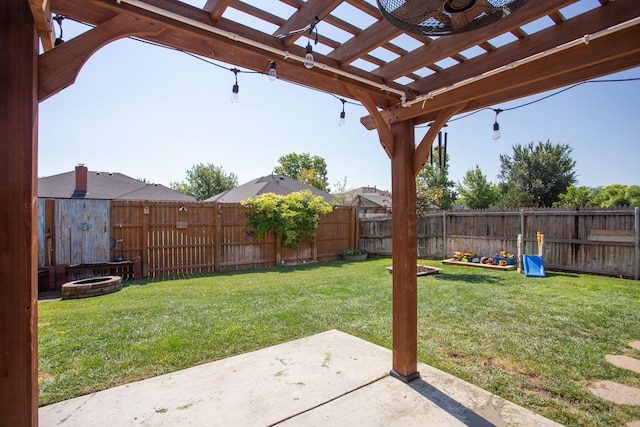 view of yard with a pergola, a fenced backyard, an outdoor fire pit, and a patio