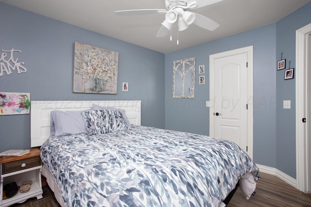 bedroom featuring wood finished floors, baseboards, and ceiling fan