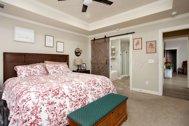 bedroom featuring a barn door, visible vents, carpet, crown molding, and a raised ceiling