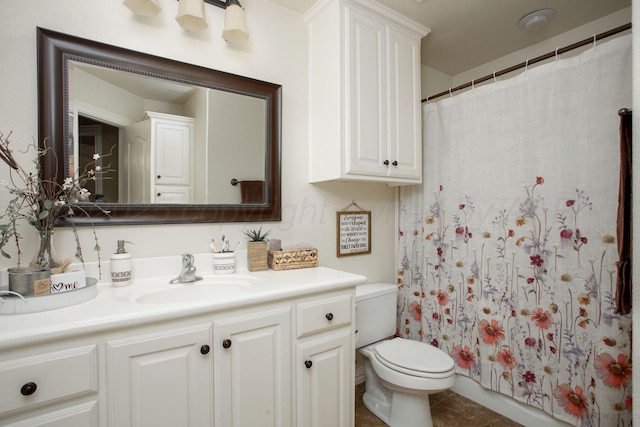 bathroom featuring a shower with curtain, tile patterned floors, vanity, and toilet