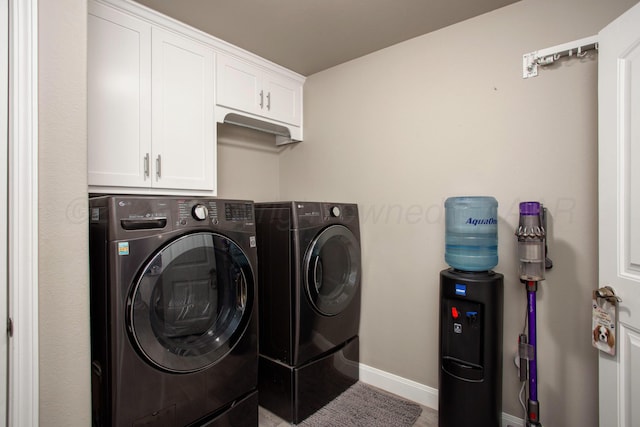 laundry room featuring independent washer and dryer and cabinets