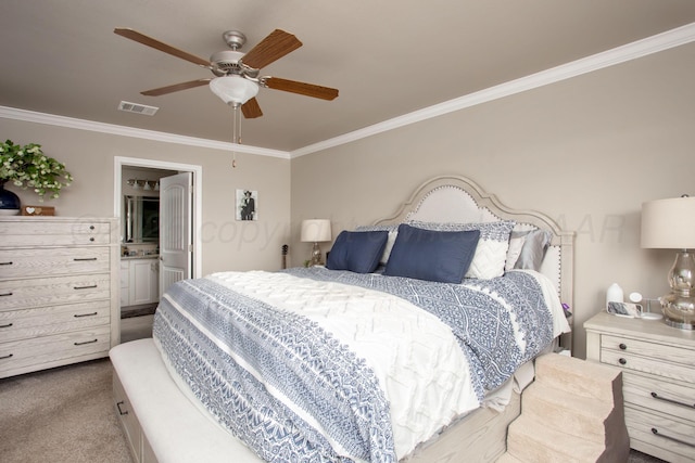 carpeted bedroom featuring ceiling fan, ornamental molding, and ensuite bath