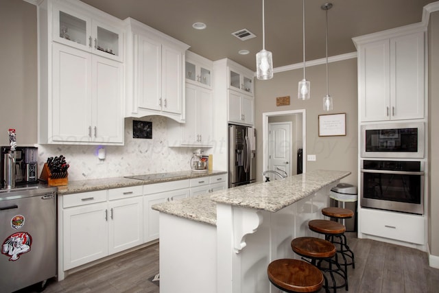 kitchen with black appliances, white cabinetry, and light stone countertops