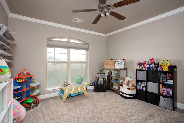 playroom with ceiling fan, crown molding, and carpet floors