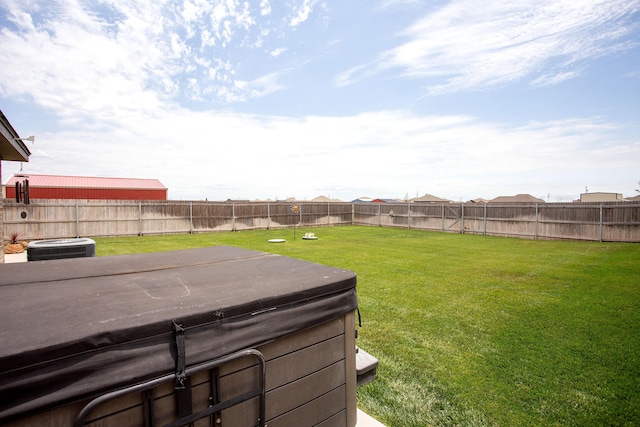 view of yard with a hot tub and central air condition unit