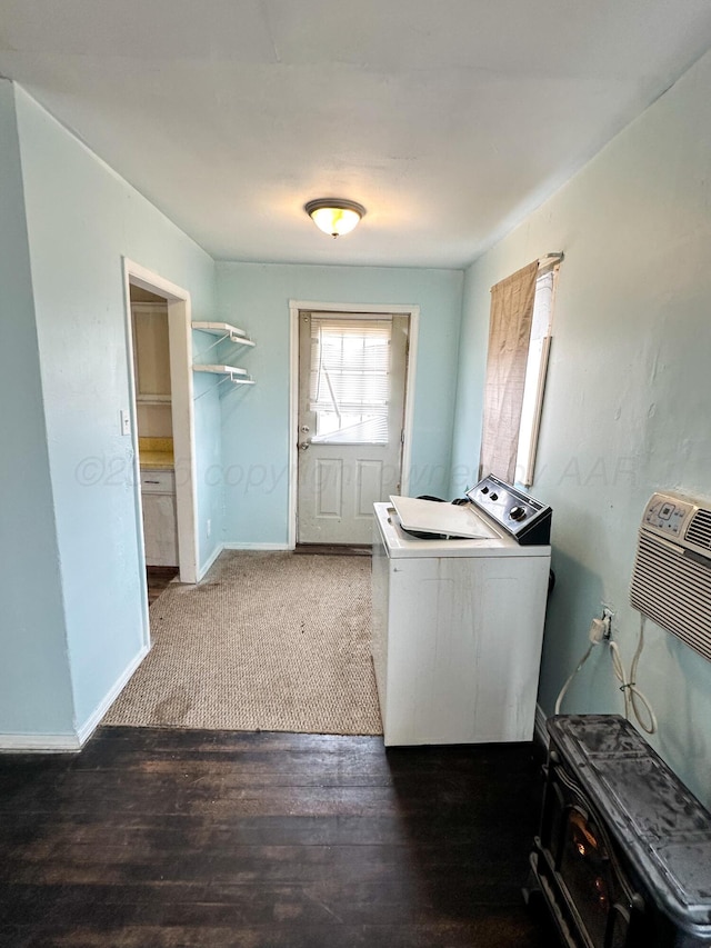 clothes washing area with dark hardwood / wood-style flooring and washer / dryer