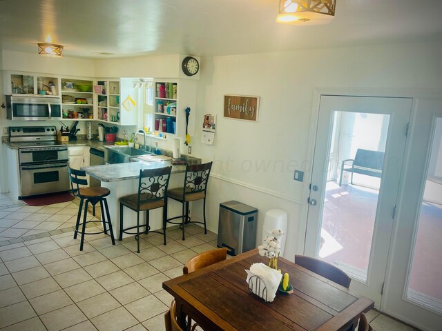 dining room featuring light tile patterned flooring and sink