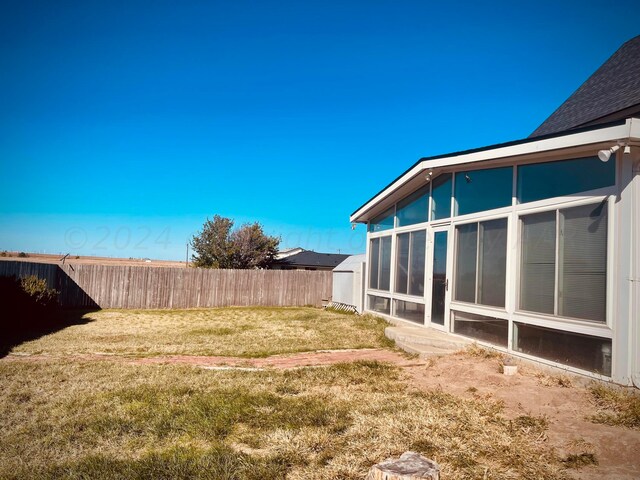 view of yard with a sunroom