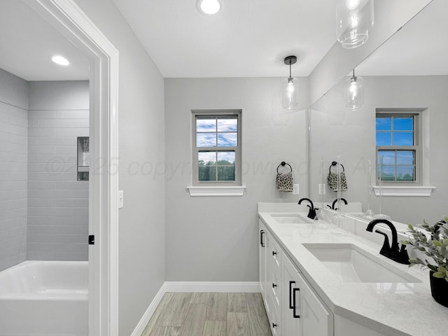 19150 Pecan Springs Rd, Amarillo, TX 79119 - full bath with baseboards, double vanity, recessed lighting, and wood finished floors
