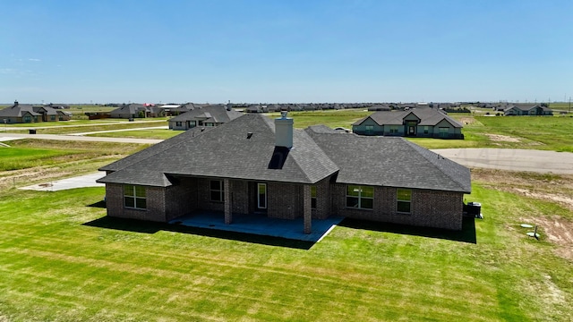 19150 Pecan Springs Rd, Amarillo, TX 79119 - back of property with brick siding, roof with shingles, a yard, and a patio