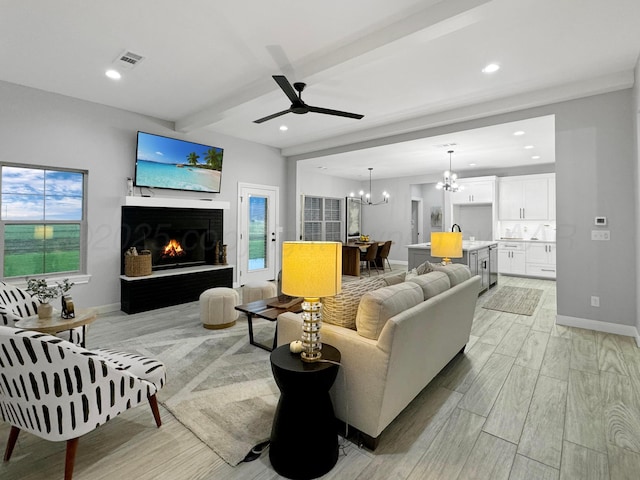 19150 Pecan Springs Rd, Amarillo, TX 79119 - living area featuring light wood finished floors, beamed ceiling, a chandelier, baseboards, and a ceiling fan