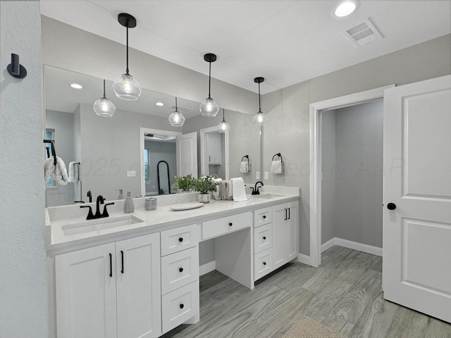 19150 Pecan Springs Rd, Amarillo, TX 79119 - full bath with double vanity, recessed lighting, wood finished floors, and baseboards
