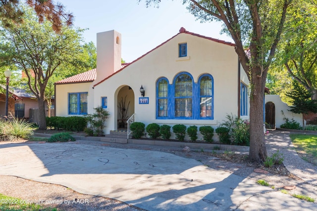 1607 S Harrison St, Amarillo, TX 79102 - mediterranean / spanish-style home featuring stucco siding, a tiled roof, and a chimney