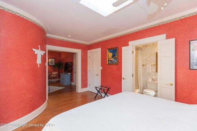 1607 S Harrison St, Amarillo, TX 79102 - bedroom with wood finished floors, ornamental molding, ensuite bathroom, and baseboards