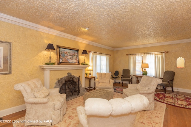 living room featuring hardwood / wood-style flooring, a textured ceiling, and ornamental molding