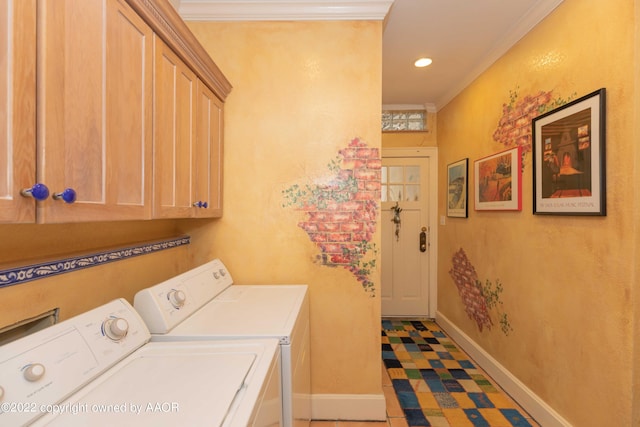 laundry room with cabinets, washer and dryer, and ornamental molding