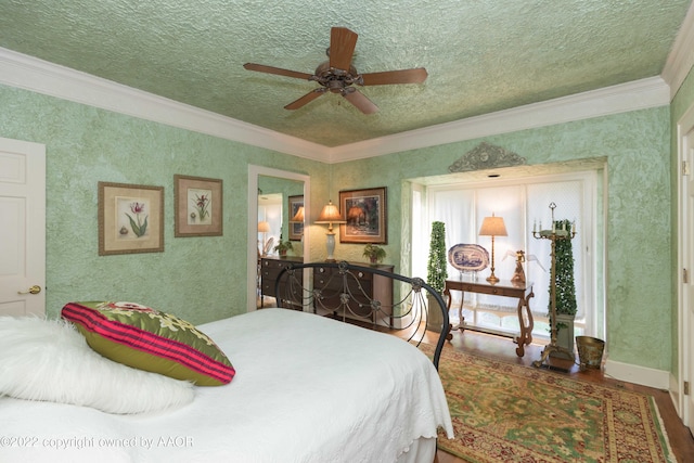 bedroom with ornamental molding, hardwood / wood-style floors, ceiling fan, and a textured ceiling