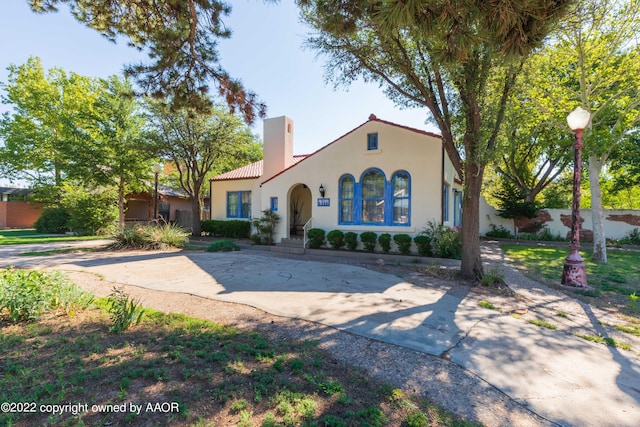 1607 S Harrison St, Amarillo, TX 79102 - mediterranean / spanish-style home featuring stucco siding, a chimney, and a tile roof