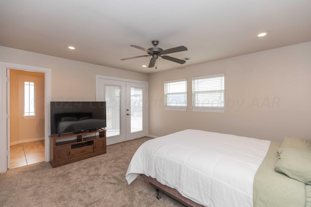 bedroom featuring ceiling fan, light carpet, access to exterior, and french doors