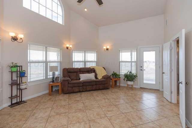 living room featuring high vaulted ceiling, light tile patterned floors, and a healthy amount of sunlight