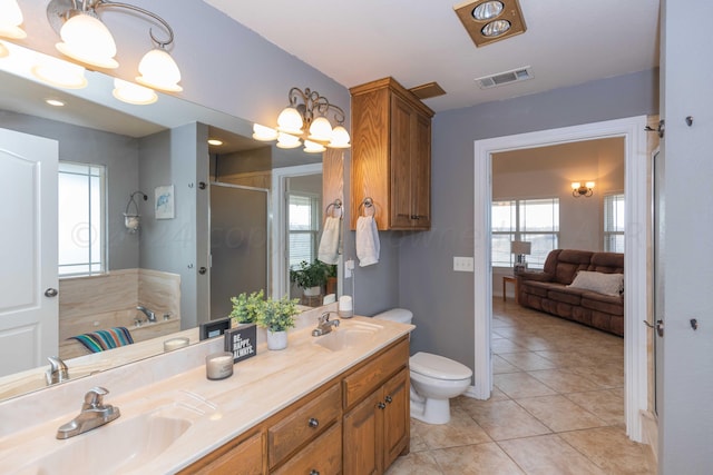 full bathroom with toilet, vanity, tile patterned flooring, and separate shower and tub