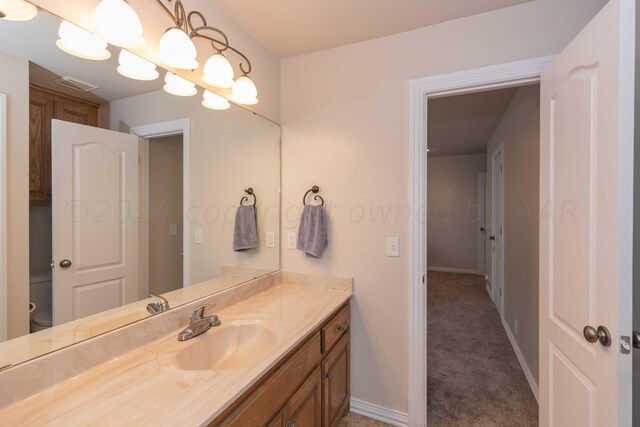 bathroom featuring vanity and toilet