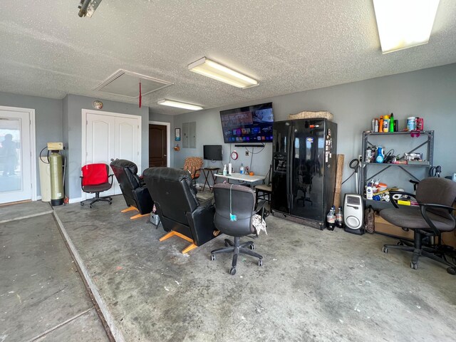 office area with a textured ceiling and concrete floors