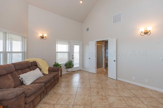 living room with high vaulted ceiling, light tile patterned floors, and plenty of natural light