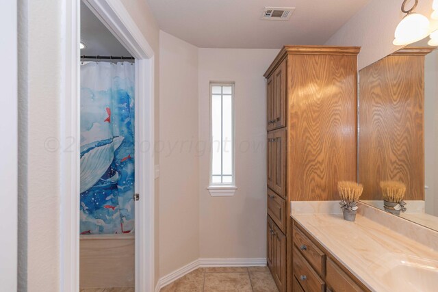 bathroom featuring tile patterned flooring and vanity