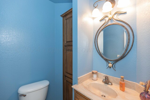 bathroom with toilet and vanity