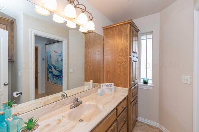 bathroom with plenty of natural light and vanity