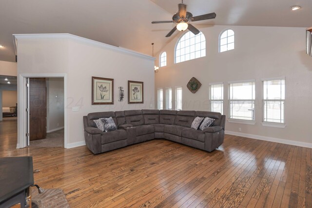 living room with high vaulted ceiling, wood-type flooring, ceiling fan, and crown molding