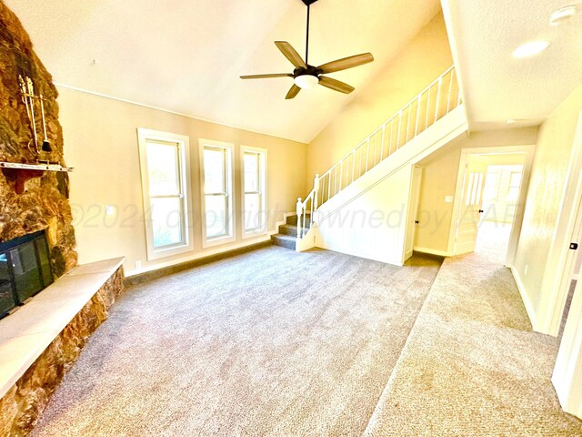 222 E 5th St, Higgins, TX 79046 - unfurnished living room featuring carpet flooring, stairway, a stone fireplace, a ceiling fan, and baseboards