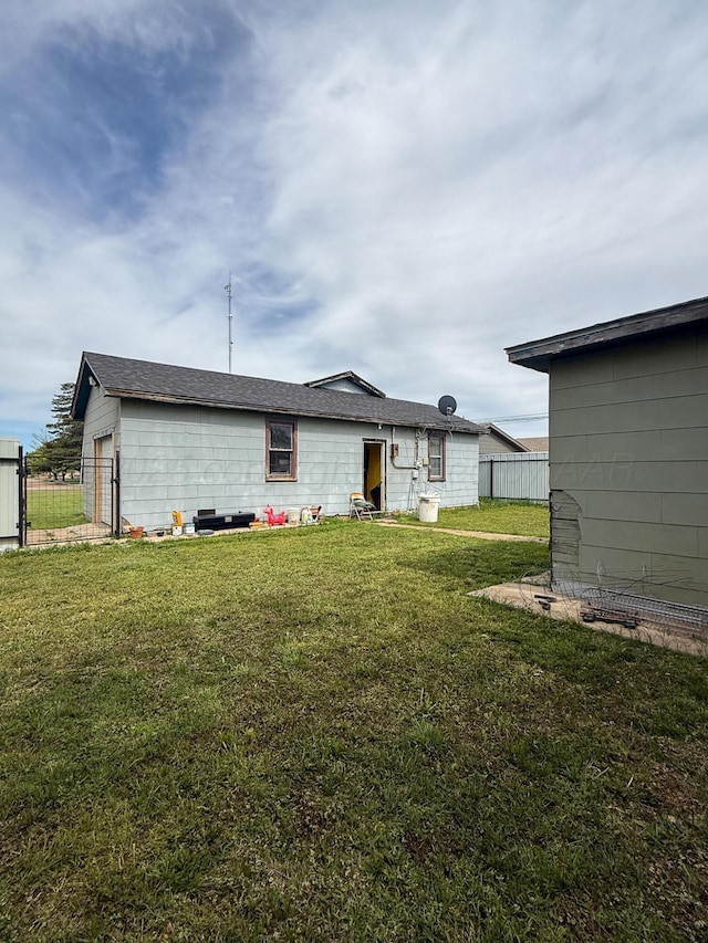 600 S Williston St, White Deer, TX 79097 - rear view of property with fence and a lawn