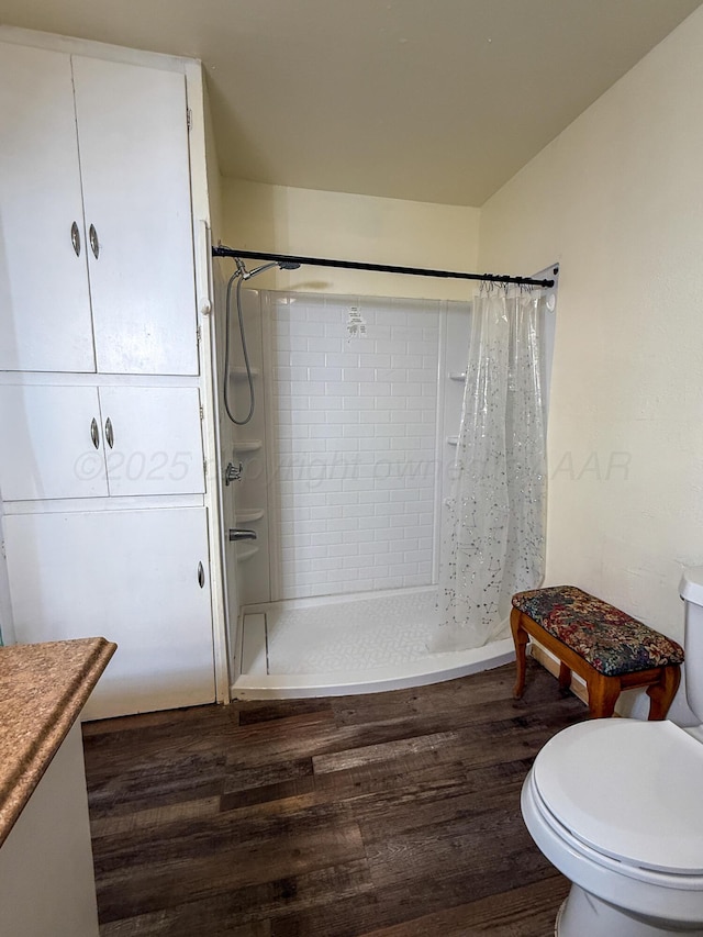 600 S Williston St, White Deer, TX 79097 - full bathroom with toilet, a tile shower, and wood finished floors