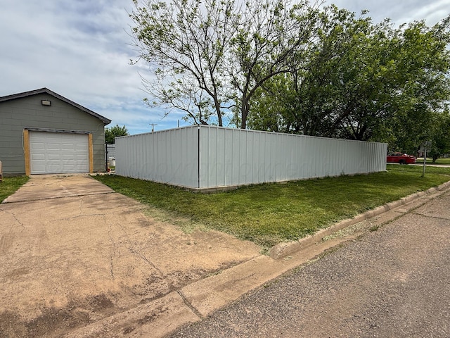 600 S Williston St, White Deer, TX 79097 - exterior space with a detached garage, a lawn, an outbuilding, and concrete driveway