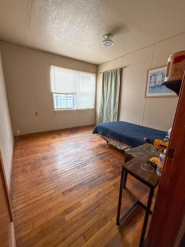 600 S Williston St, White Deer, TX 79097 - bedroom with wood-type flooring and a textured ceiling