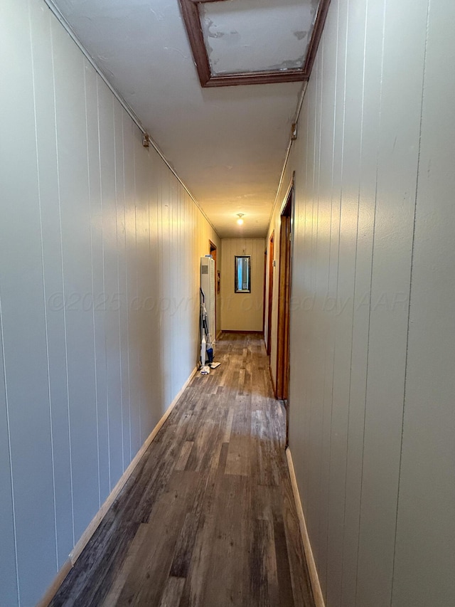 600 S Williston St, White Deer, TX 79097 - hallway with wood-type flooring, wood walls, and attic access