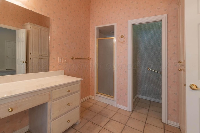 7402 Park Ridge Dr, Amarillo, TX 79119 - full bath featuring wallpapered walls, a shower stall, vanity, tile patterned floors, and baseboards