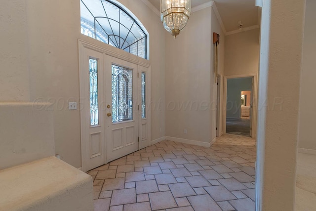 7402 Park Ridge Dr, Amarillo, TX 79119 - entrance foyer with ornamental molding, a chandelier, light stone finish flooring, and a towering ceiling