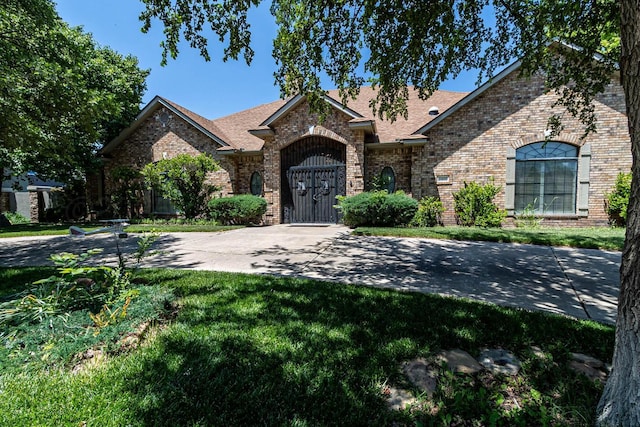 7402 Park Ridge Dr, Amarillo, TX 79119 - view of front of property featuring brick siding, a front lawn, and a shingled roof