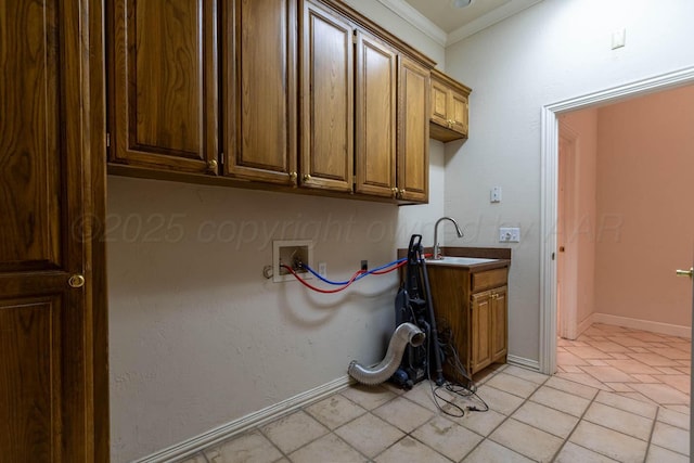 7402 Park Ridge Dr, Amarillo, TX 79119 - laundry room with washer hookup, cabinet space, ornamental molding, light tile patterned flooring, and baseboards
