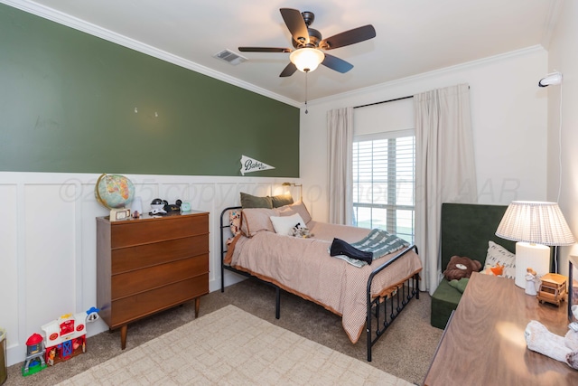 25 Nicci Ln, Canyon, TX 79015 - carpeted bedroom featuring ornamental molding, a wainscoted wall, a ceiling fan, and a decorative wall